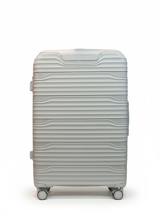 White suitcase on a tiled floor with blurred people in the background